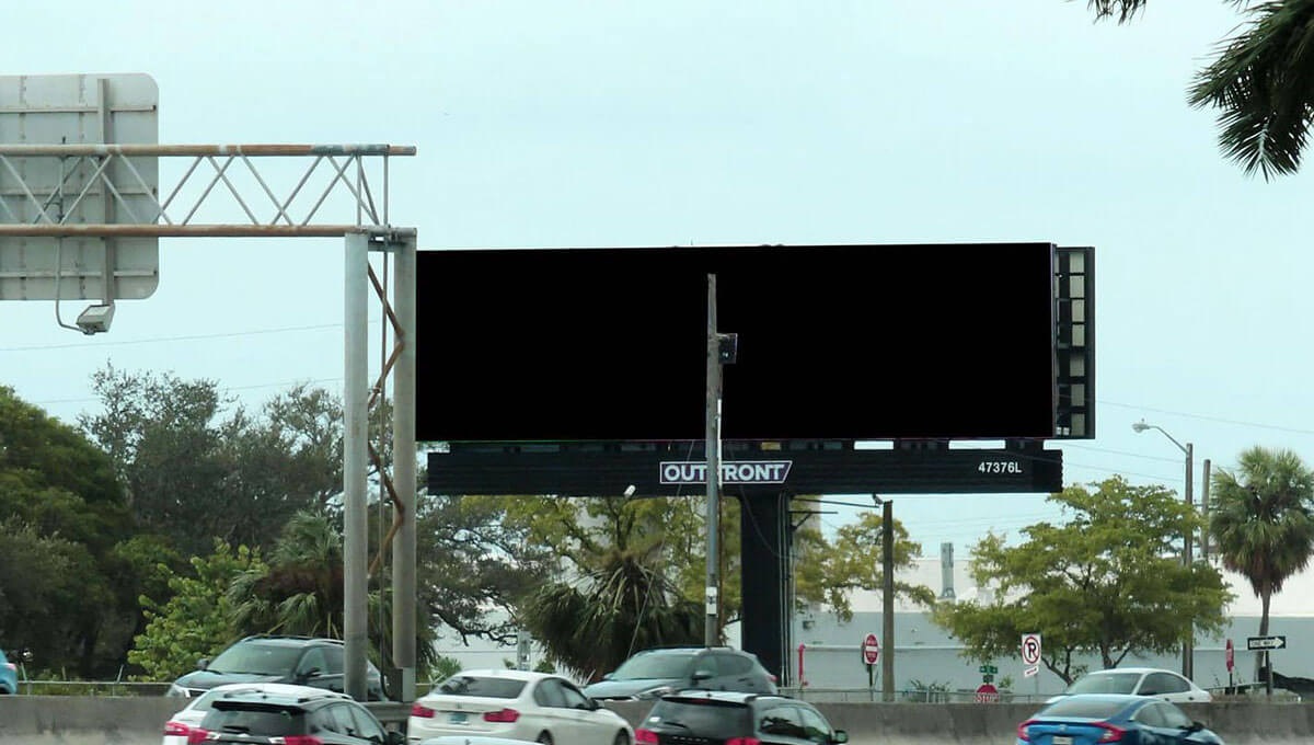 Highway scene featuring an empty Outfront digital billboard, ready for advertisement placement.
